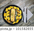 Fried salmon fillet with potato wedges on plate, top view 101582655