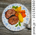Braised roll roast with potato wedges and carrots on plate. High quality photo 101582660