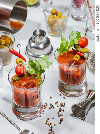Bloody mary cocktail glasses with bar shaker,jigger,spoon on light Bloody mary cocktail glasses with bar shaker,jigger,spoon on light 101582820
