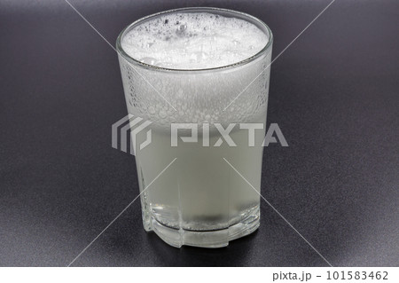 Dissolving instant effervescent tablets in a glass of water closeup Dissolving instant effervescent tablets in a glass of water closeup 101583462