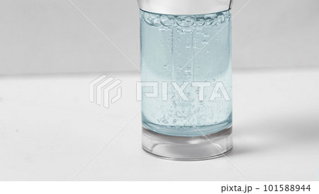 Hyaluronic acid in glass bottle on white background with clipping path close-up, Liquid green gel or serum bubbles, Medicine and Pharmacology. Beauty skin care concept Beauty and spa. 101588944