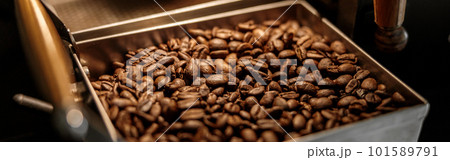 Industrial coffee roasting machine with brown coffee beans Industrial coffee roasting machine with brown coffee beans 101589791