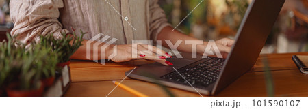 CLose up of female florist working online from own floral studio and check customers order CLose up of female florist working online from own floral studio and check customers order 101590107