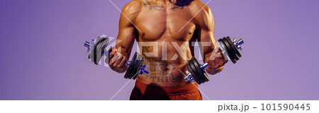 Muscular man doing exercise with weight dumbbells on studio background. Strength and motivation Muscular man doing exercise with weight dumbbells on studio background. Strength and motivation 101590445