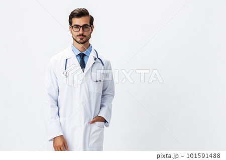 Male doctor in white coat and eyeglasses and stethoscope looking at patient X-rays for diagnosis on white isolated background, space for copy, space for text, health 101591488