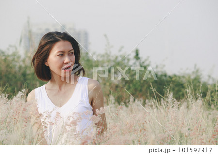 portrait of young woman with meadow view 101592917