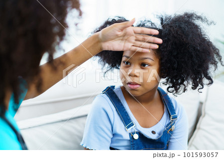 African American ethnicity female doctor and little girl in hospital, pediatrician taking to a little girl who laying down on the bed or sofa in hospital to talk about her sickness. African American ethnicity female doctor and little girl in hospital, pediatrician taking to a little girl who laying down on the bed or sofa in hospital to talk about her sickness. 101593057