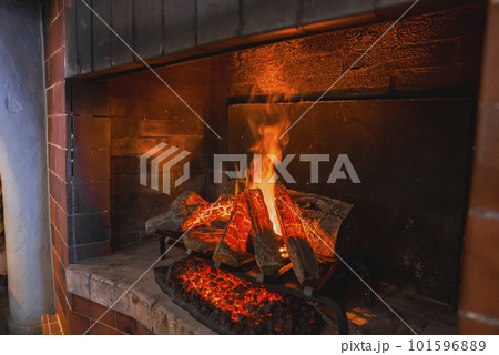 Beautiful luxury interior design with fireplace burning firewood in hotel room, luxury travel concept for tourists 101596889