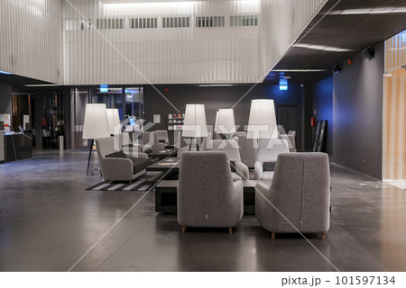 Empty armchairs and tables with electric lamps arranged in modern lobby at luxurious hotel, luxury travel concept for tourists 101597134