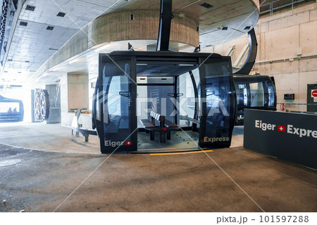 Gondola lift with empty seats and eiger express text on open doors inside modern Grindelwald terminal at Jungfrau, Switzerland, winter holiday concept for tourists 101597288