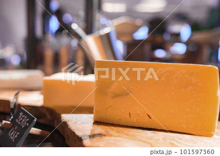 Closeup of mountain cheese pieces with tag on wooden table at luxurious hotel restaurant, luxury travel and food concept 101597360