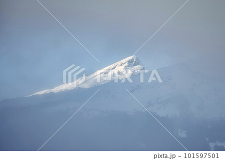 Beautiful and idyllic view of snow covered majestic Bernese mountain under sky during foggy weather at Jungfrau, Switzerland, winter holiday and nature concept Beautiful and idyllic view of snow covered majestic Bernese mountain under sky during foggy weather at Jungfrau, Switzerland, winter holiday and nature concept 101597501