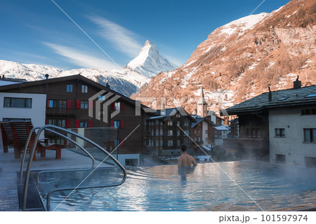 Luxury infinity outdoors pool with an amazing view at the Matterhorn peak in Zermatt, Switzerland.  101597974