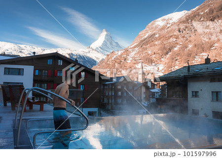 Luxury infinity outdoors pool with an amazing view at the Matterhorn peak in Zermatt, Switzerland. Luxury infinity outdoors pool with an amazing view at the Matterhorn peak in Zermatt, Switzerland. 101597996
