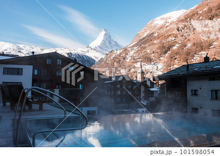 Luxury infinity outdoors pool with an amazing view at the Matterhorn peak in Zermatt, Switzerland.  101598054