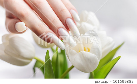 Female hand with spring nail design. Female hand with spring nail design. 101599385