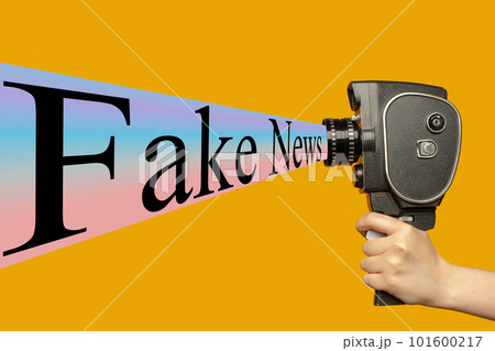 Contemporary art collage. Human hand holding movie camera and spreading fake news. 101600217