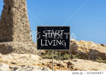Start living symbol. Concept words Start living on beautiful black chalk blackboard. Beautiful stone blue sky background. Business and Start living concept. Copy space. Start living symbol. Concept words Start living on beautiful black chalk blackboard. Beautiful stone blue sky background. Business and Start living concept. Copy space. 101604867