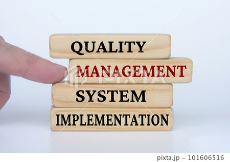 Quality Management System Implementation text on wooden blocks. Business culture and Operational excellence concept 101606516