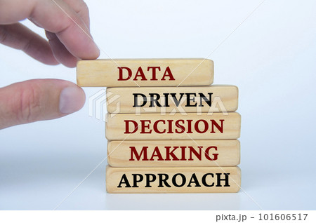 Hand holding wooden block with text Data Driven Decision Making Approach text on wooden blocks. Business culture and Operational excellence concept 101606517