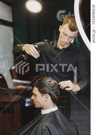Man work with hair. Hairdresser with a client. Man work with hair. Hairdresser with a client. 101606816