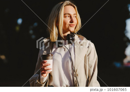 Portrait of beautiful blond. Model in summer city. Girl with cup of coffee. Portrait of beautiful blond. Model in summer city. Girl with cup of coffee. 101607065