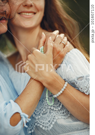 Women in a summer forest. Lady in a blue dress. Family posing and embracing. 101607110