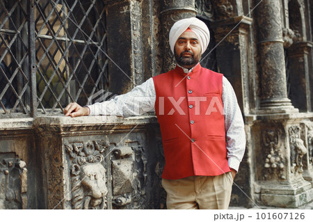 Indian man in a city. Male in a traditional turban. Hinduist in a summer city. 101607126