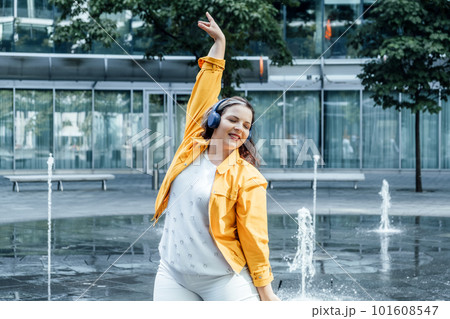 Mind-body positivity taking care of both the mind and body. practices such as meditation, yoga, and self-care to promote self-love and acceptance. Outdoor portrait of Woman in headset 101608547