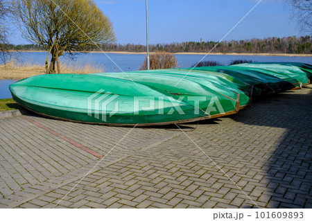 a lot of plastic boats in green color on the shore a lot of plastic boats in green color on the shore 101609893