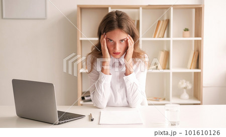 Keep anger. Mad woman. Work difficulties. Desperate lady holding temples sitting desk opened laptop feeling aggression light room interior. 101610126
