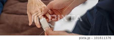 Nurse checking with fingertip pulse oximeter oxygen saturation of patient blood in hospital Nurse checking with fingertip pulse oximeter oxygen saturation of patient blood in hospital 101611376