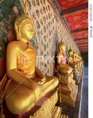 Gallery with old vessels of the seated Buddha in the Buddhist temple Wat Arun. Bangkok, Thailand Gallery with old vessels of the seated Buddha in the Buddhist temple Wat Arun. Bangkok, Thailand 101611925