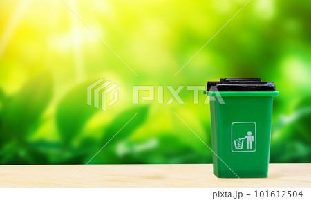 Green garbage for organic biodegradable waste, separate waste collection and recycling concept with nature background, environment concept copy space 101612504