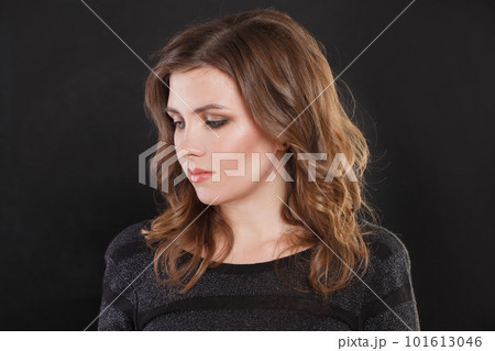 Fashion beauty portrait of nice elegant woman with makeup and brown wavy hair on black background Fashion beauty portrait of nice elegant woman with makeup and brown wavy hair on black background 101613046