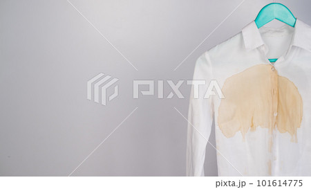 Women's office white shirt with a stain of coffee on a white background. Copy space.  101614775