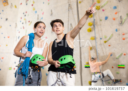 fitness instructors in gym discuss alpinist practice artificial rock climbing wall fitness instructors in gym discuss alpinist practice artificial rock climbing wall 101619737