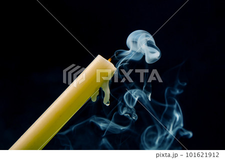 Smoke from an extinguished candle on a dark background Smoke from an extinguished candle on a dark background 101621912