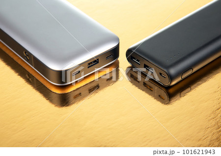 Powerbank portable on a golden background. Electronic devices for charging gadgets and smartphones 101621943