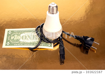 Dollars, LED lamp and electric cable plug. Saving electricity. Energy saving concept Dollars, LED lamp and electric cable plug. Saving electricity. Energy saving concept 101622167