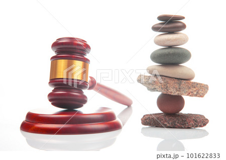 pyramid of stacked stones and a gavel of justice and law on a white background pyramid of stacked stones and a gavel of justice and law on a white background 101622833
