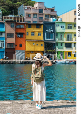 woman traveler visiting in Taiwan, Tourist with backpack and hat sightseeing in Keelung, Colorful Zhengbin Fishing Port, landmark and popular attractions near Taipei city . Asia Travel concept 101622880