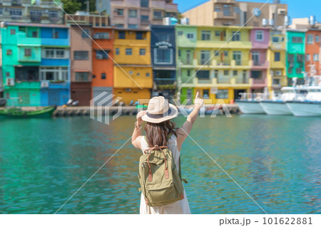 woman traveler visiting in Taiwan, Tourist with backpack and hat sightseeing in Keelung, Colorful Zhengbin Fishing Port, landmark and popular attractions near Taipei city . Asia Travel concept 101622881