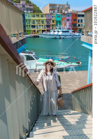 woman traveler visiting in Taiwan, Tourist with hat sightseeing in Keelung, Colorful Zhengbin Fishing Port, landmark and popular attractions near Taipei city . Asia Travel concept 101622887