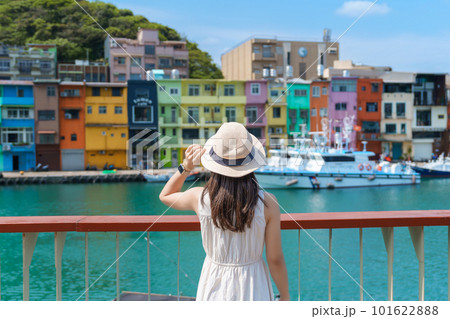 woman traveler visiting in Taiwan, Tourist with hat sightseeing in Keelung, Colorful Zhengbin Fishing Port, landmark and popular attractions near Taipei city . Asia Travel concept 101622888