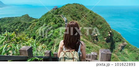 woman traveler visiting in Taiwan, Tourist with backpack sightseeing in Bitou Cape Hiking Trail, New Taipei City. landmark and popular attractions near Taipei. Asia Travel concept 101622893