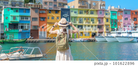 woman traveler visiting in Taiwan, Tourist with backpack and hat sightseeing in Keelung, Colorful Zhengbin Fishing Port, landmark and popular attractions near Taipei city . Asia Travel concept 101622896
