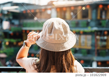 woman traveler visiting in Taiwan, Tourist with hat and backpack sightseeing in Jiufen Old Street village with Tea House background. landmark and popular attractions near Taipei city. Travel concept 101622909