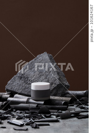 Cream jar, gray stone and bamboo charcoal on dark background. Mock up cream container. Skin care concept. Organic cosmetics, beauty products concept Cream jar, gray stone and bamboo charcoal on dark background. Mock up cream container. Skin care concept. Organic cosmetics, beauty products concept 101624167