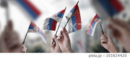 A group of people holding small flags of the Serbia in their hands 101624420